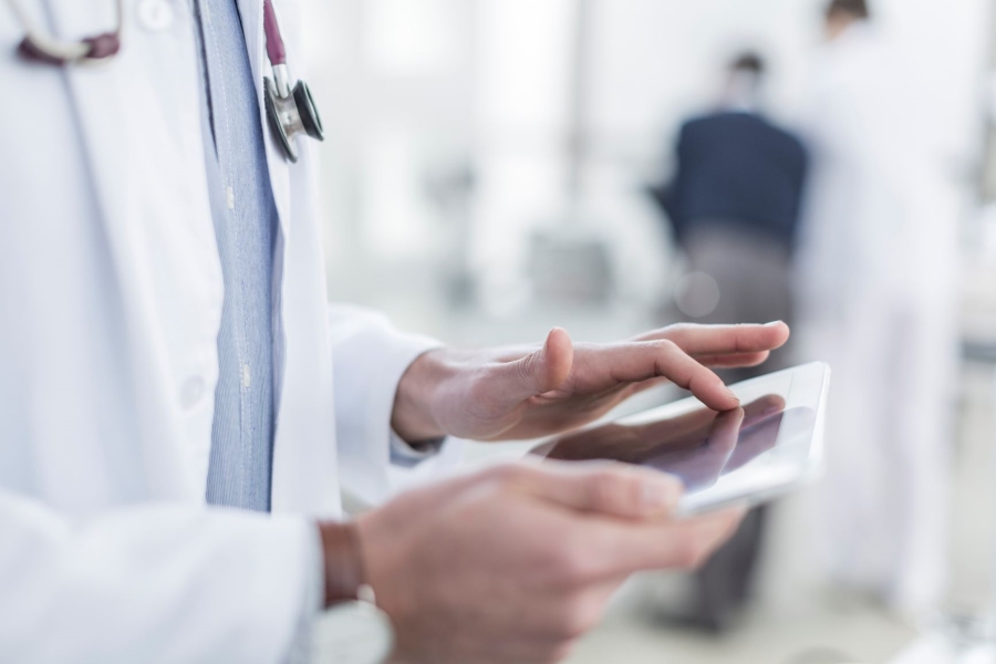 A doctor uses a tablet