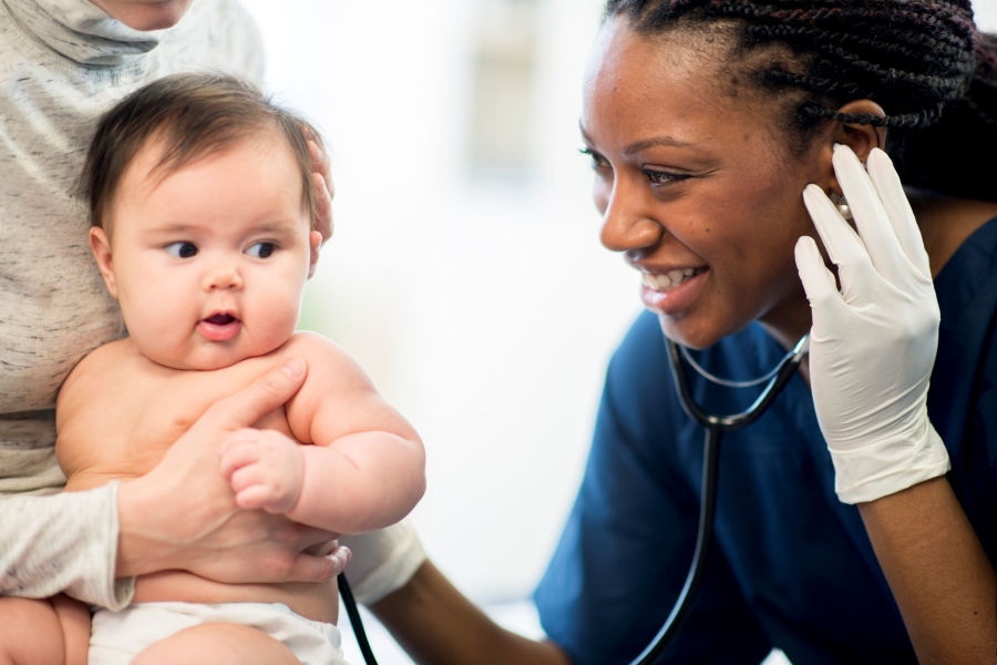 A woman in healthcare and a baby